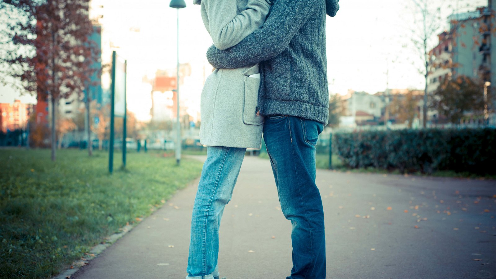 Couple hugging on sidewalk